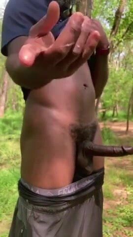 Black muscular exhibitionist stroking in the woods
