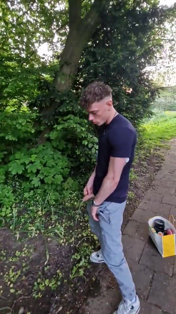 Boy pisses in a park