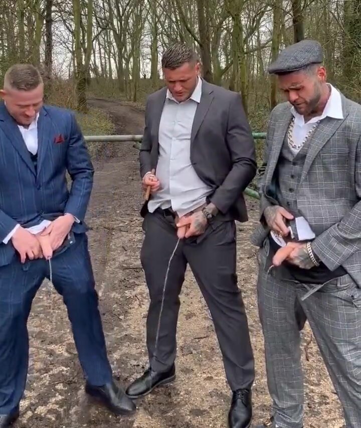 Three gentlemen urinating together