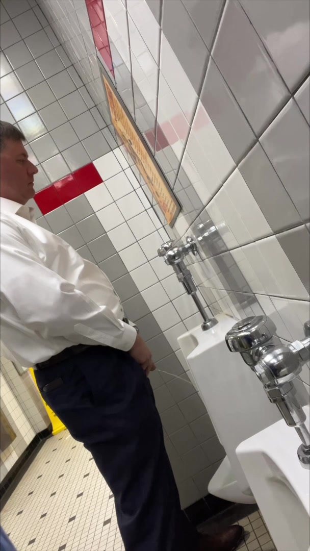 Business guy at urinal