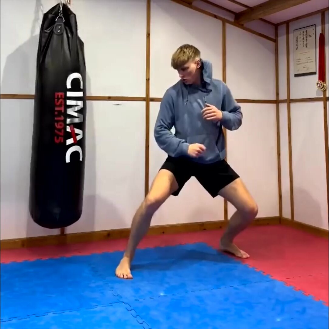 Martial Artist Kicking & Stretching