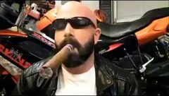 Hot leather biker and his big cigar