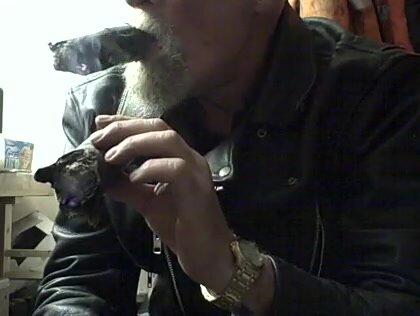 Leather dad smokes two huge cigar nubs