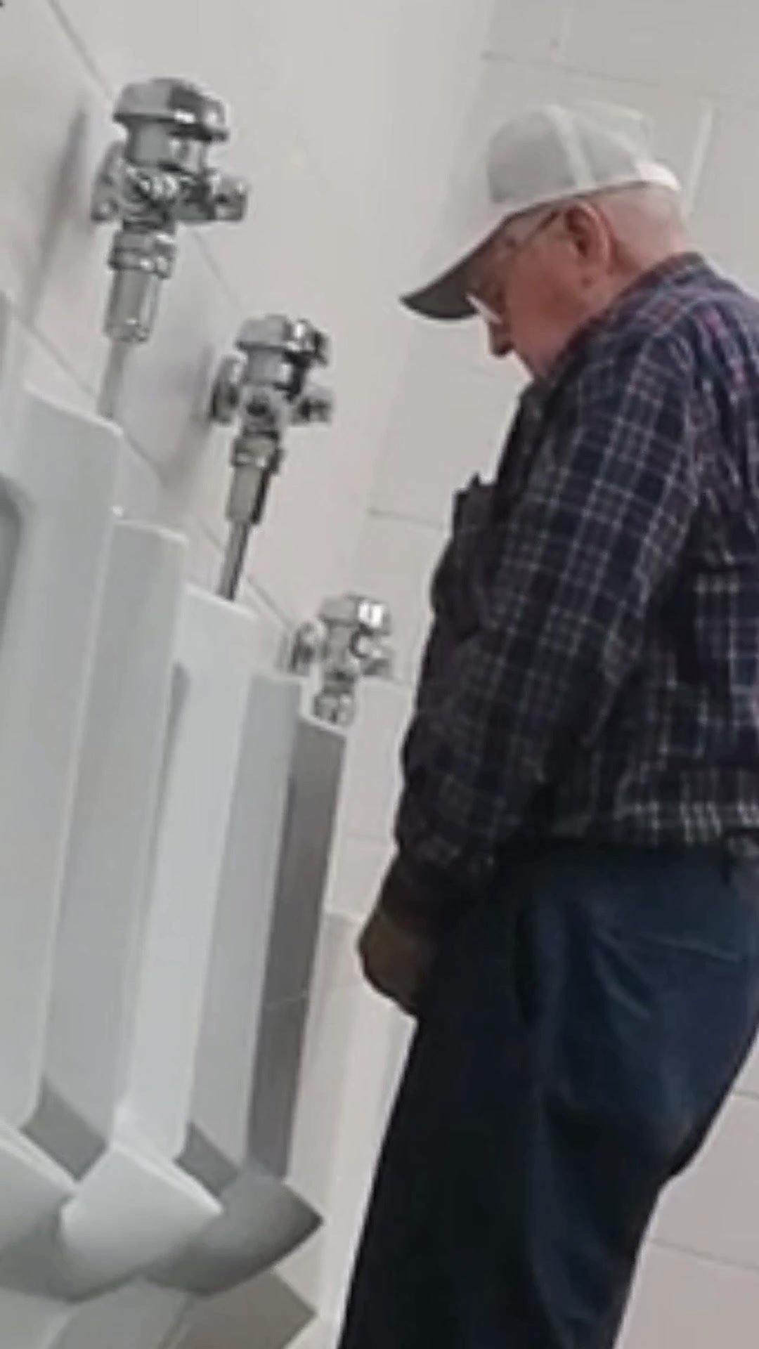 Grandpa shakes big long cock at urinal