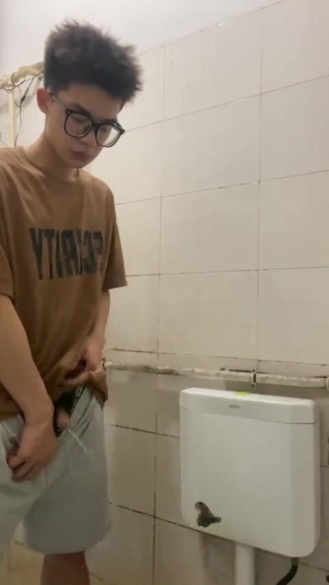 A male is pissing in the toilet. - video 18