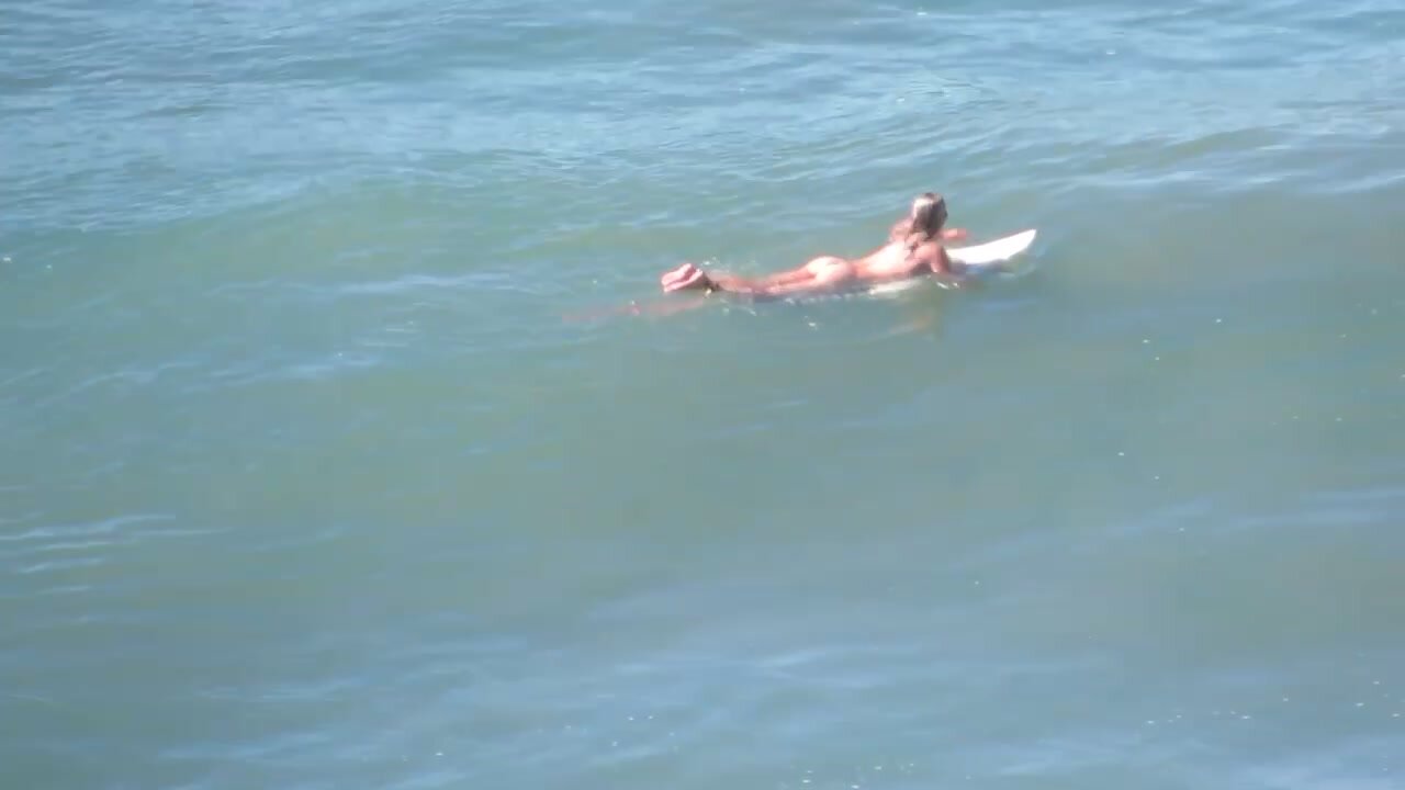 Girl surfs naked