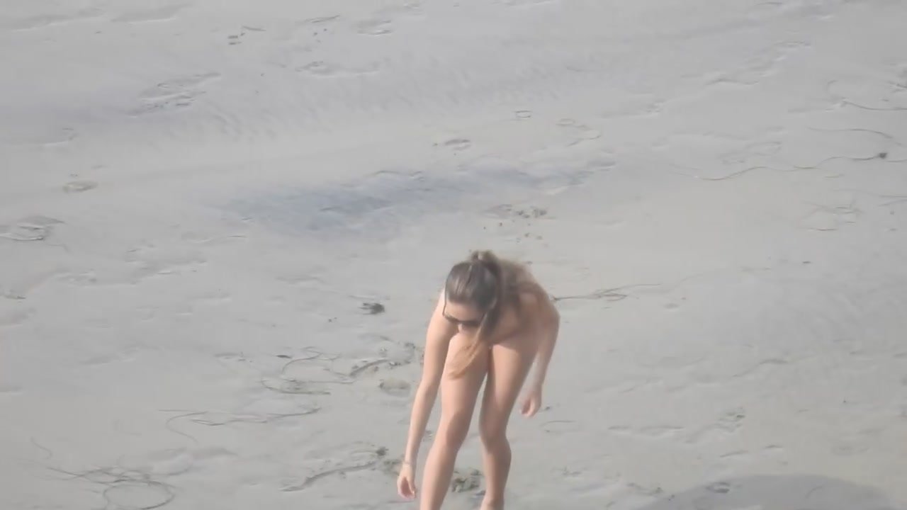 Naked girl plays frisbee on nude beach