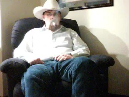 Sexy cigar smoking cowboy