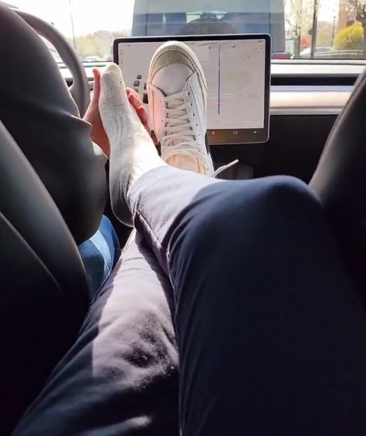 Master Alpha gets his socked feet tickled in the car