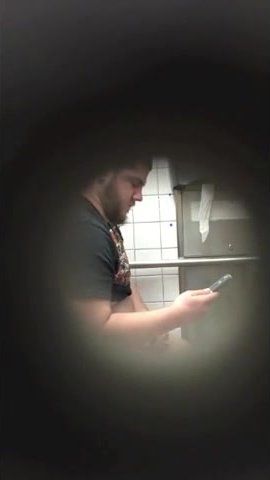 Spy on a stocky stud jerking off in college bathroom