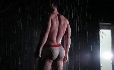 Young bodybuilder and Model Flexing hard under shower