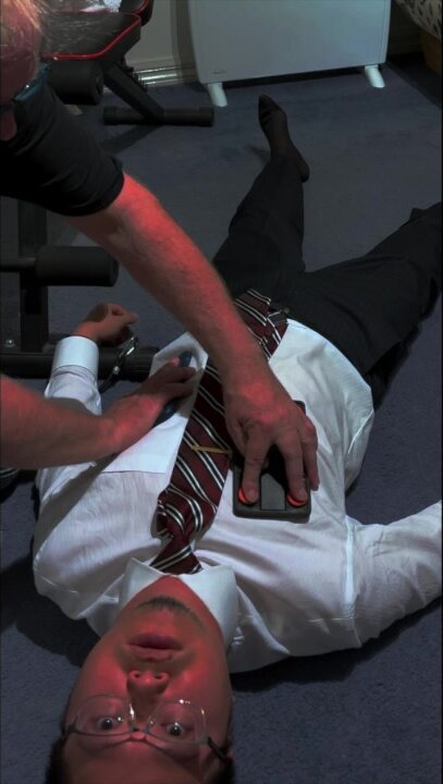 Resuscitating man in shirt and tie