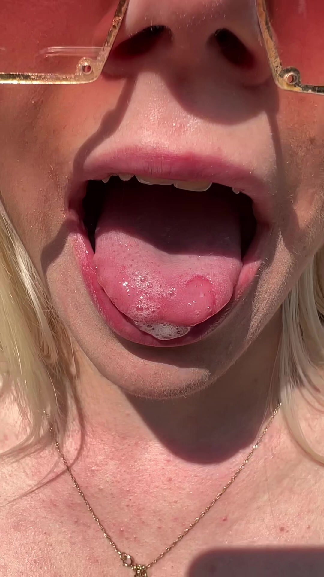 Teen is showing you her wet mouth tongue and throat