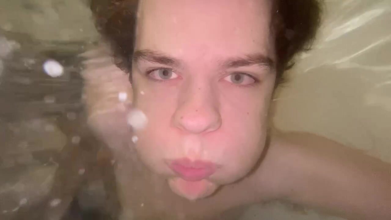 Boy With Puffy Cheeks Bubbling Underwater