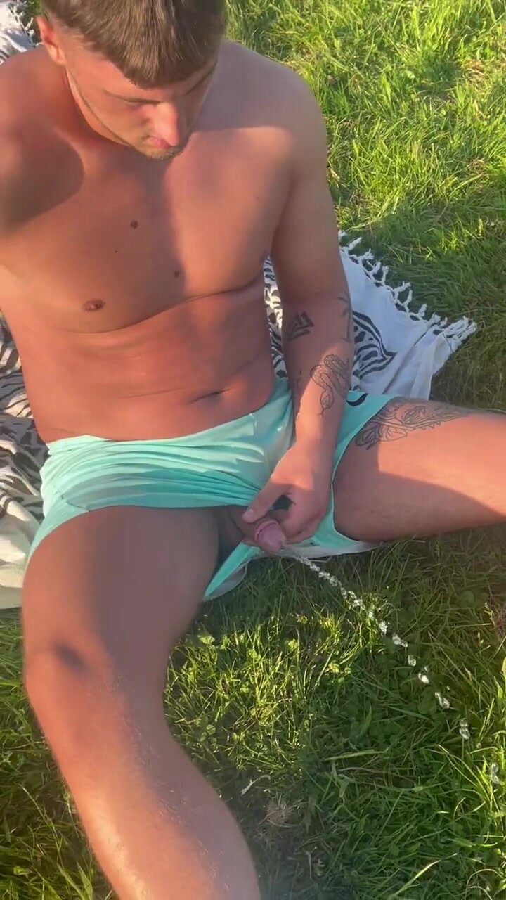 uncut softie pissing in the grass