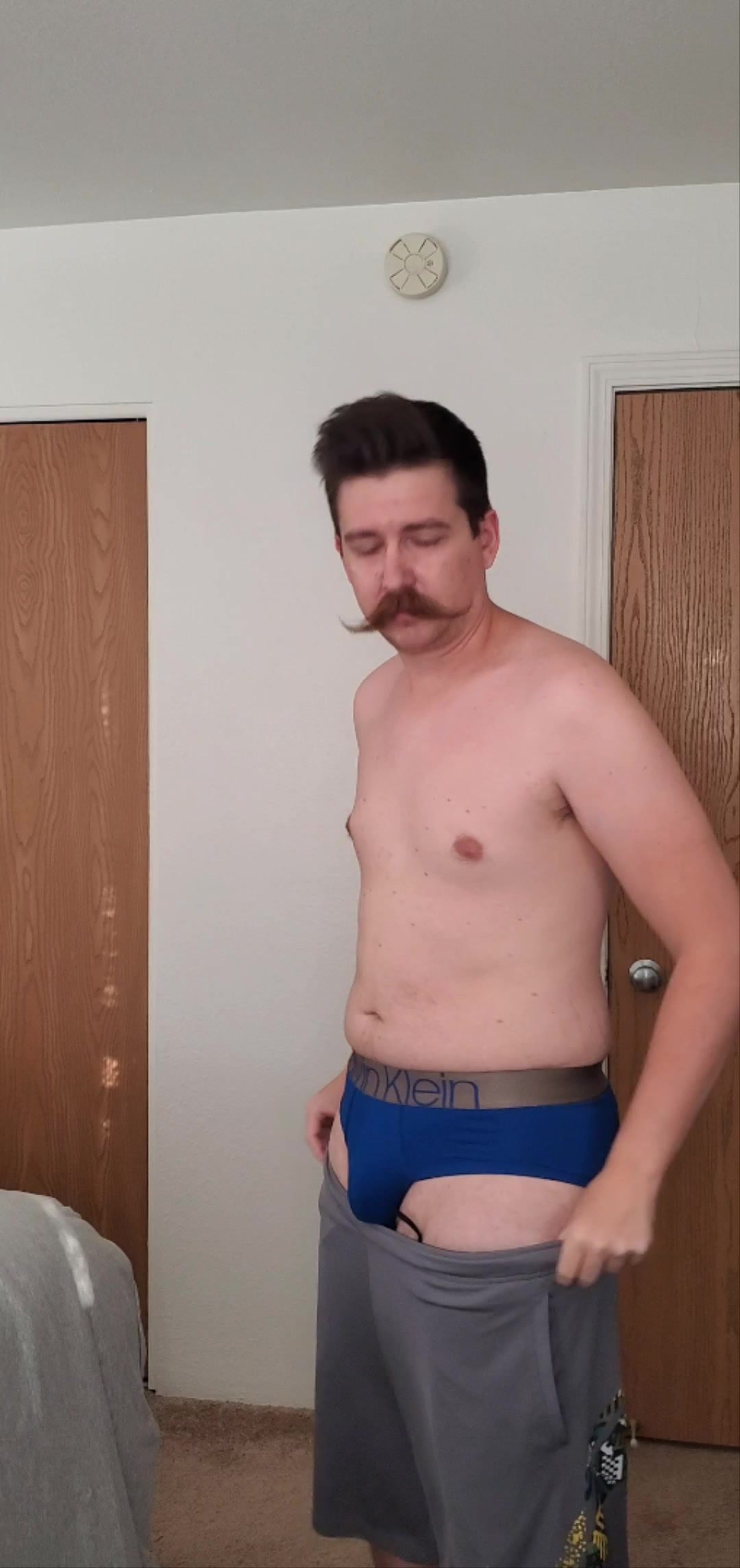 mustache faggot strips down