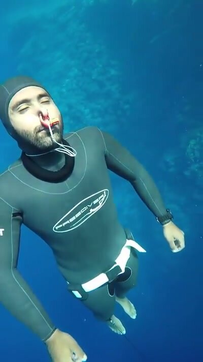 Barefaced underwater in tight wetsuit - video 4