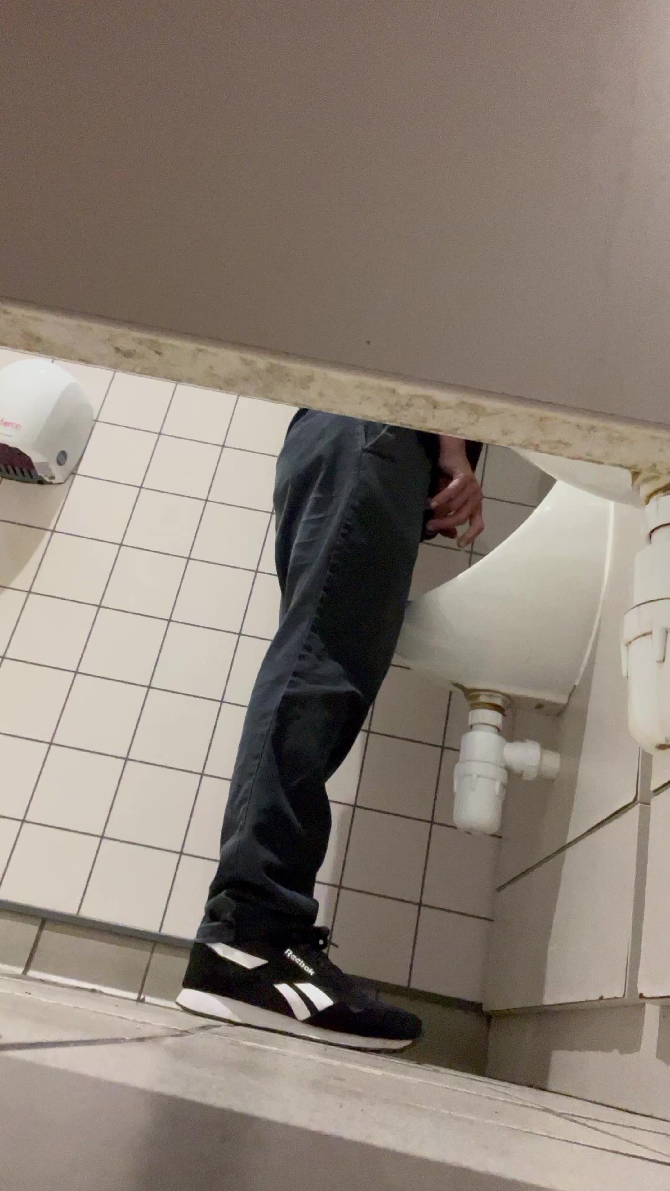 Uncut shy guy pissing at urinal