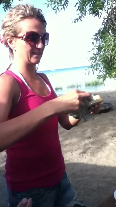 mom swallows live fish with beer