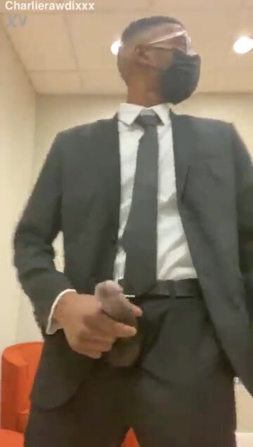 Suited guy has a quick wank in the library