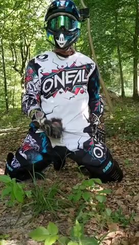 MX biker jerks and pisses in the woods