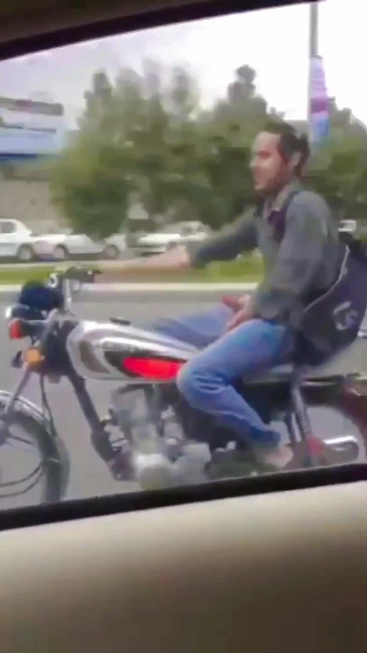 22 Motorbikist showing off while riding it