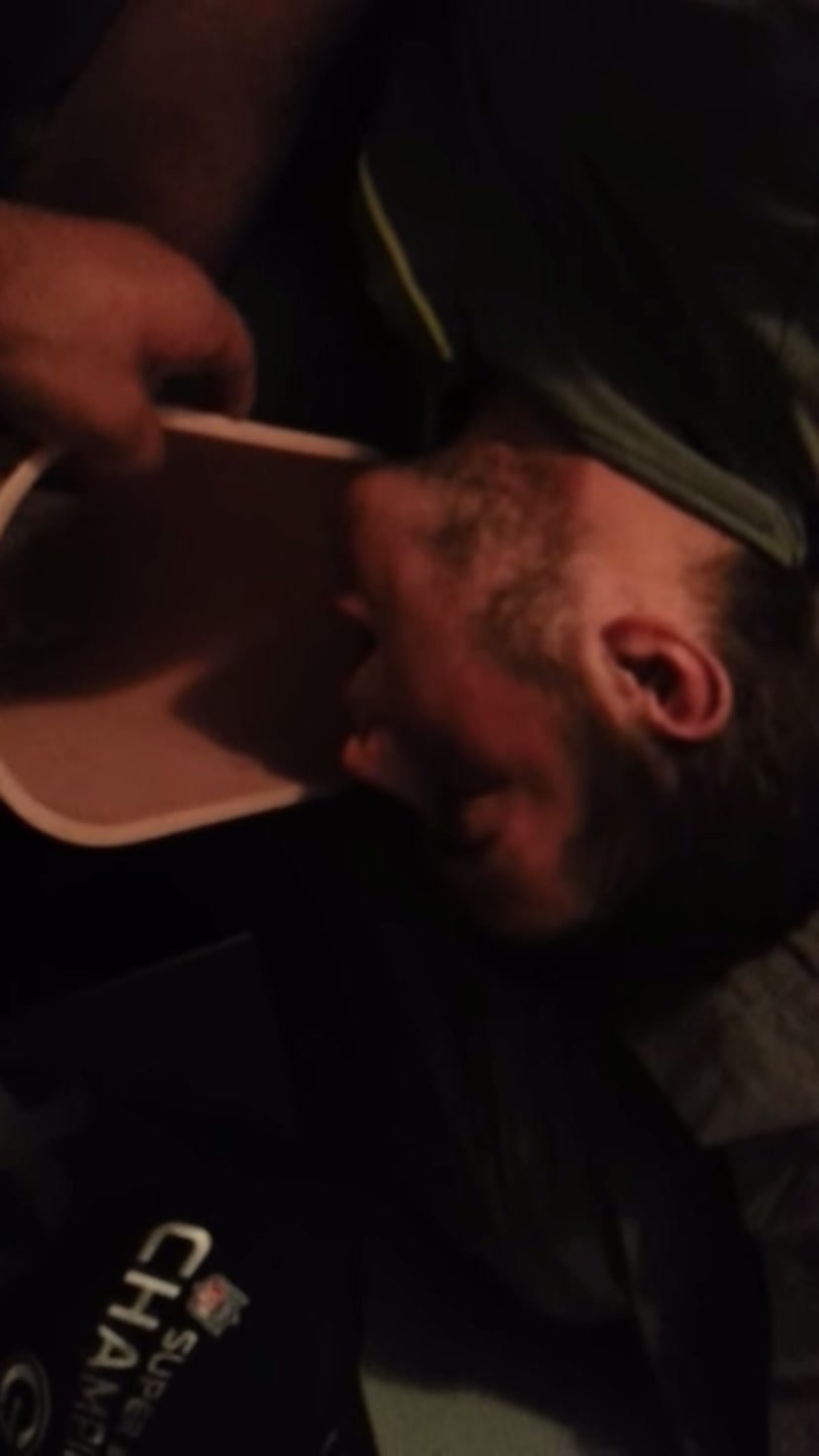 Guy puking in bucket