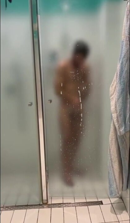Sexy man takes a shower behind matt glass. Part 1