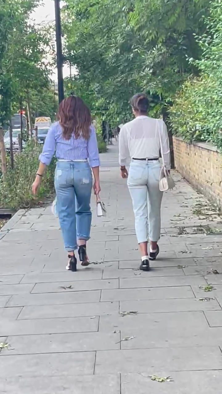 A pair of slim brunettes in jeans