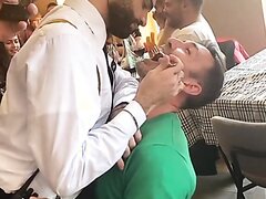 Hot gay waiter sits on straight guy's lap and feeds him