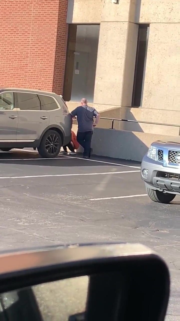 Guy watches over his girl peeing behind a SUV