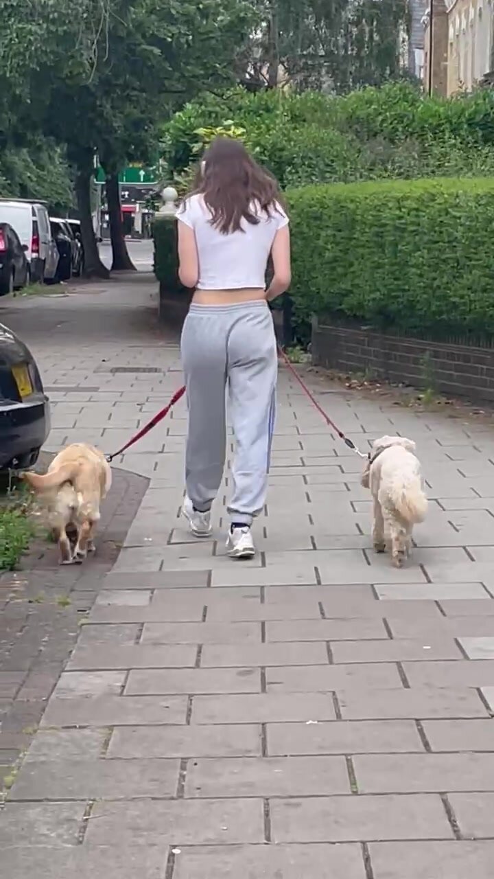 Brunette teen walking the dog