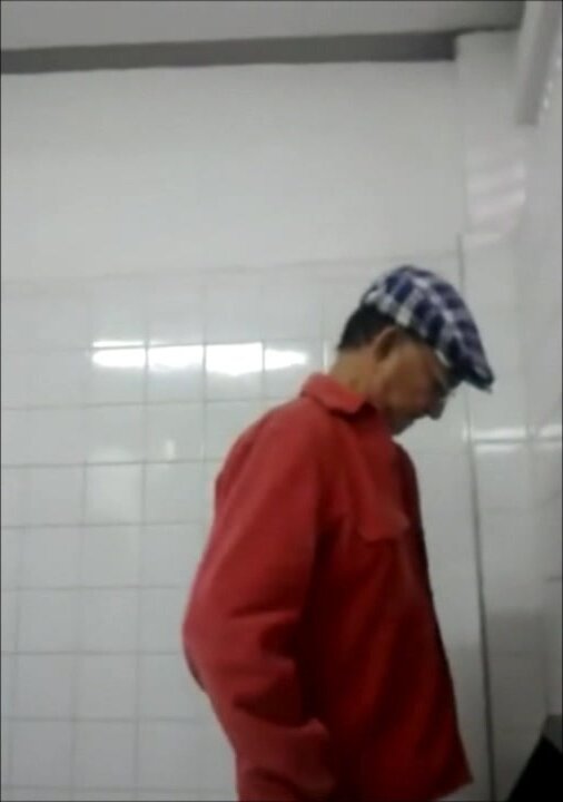 Mature man at urinal