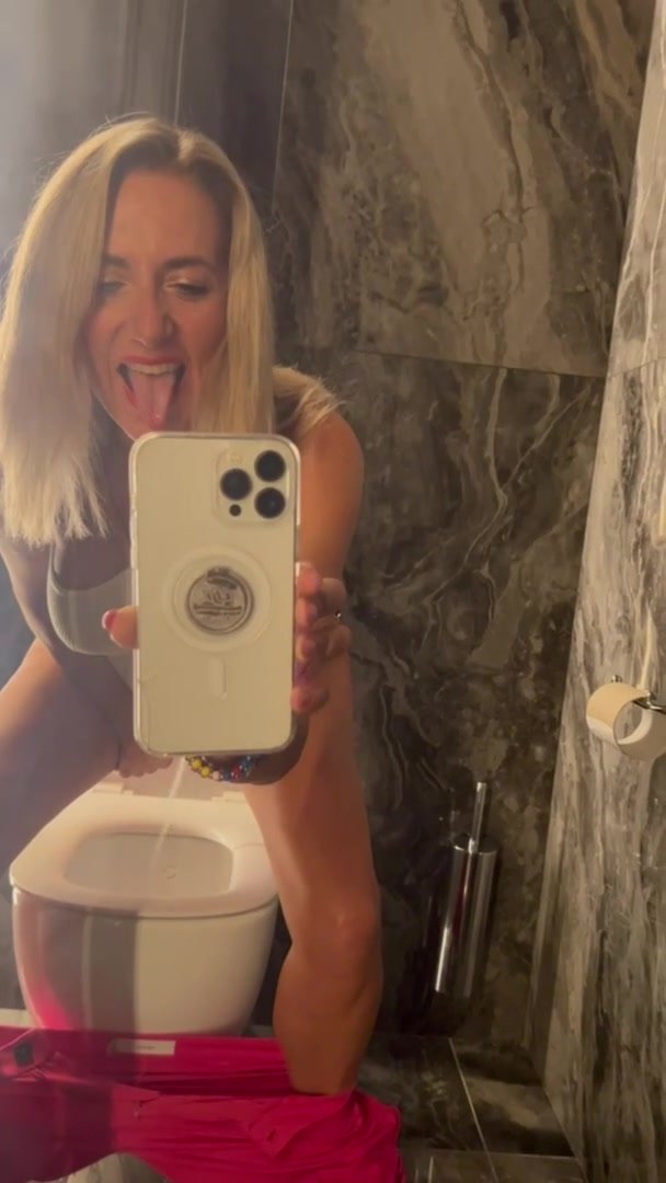 Blond milf jets into the toilet