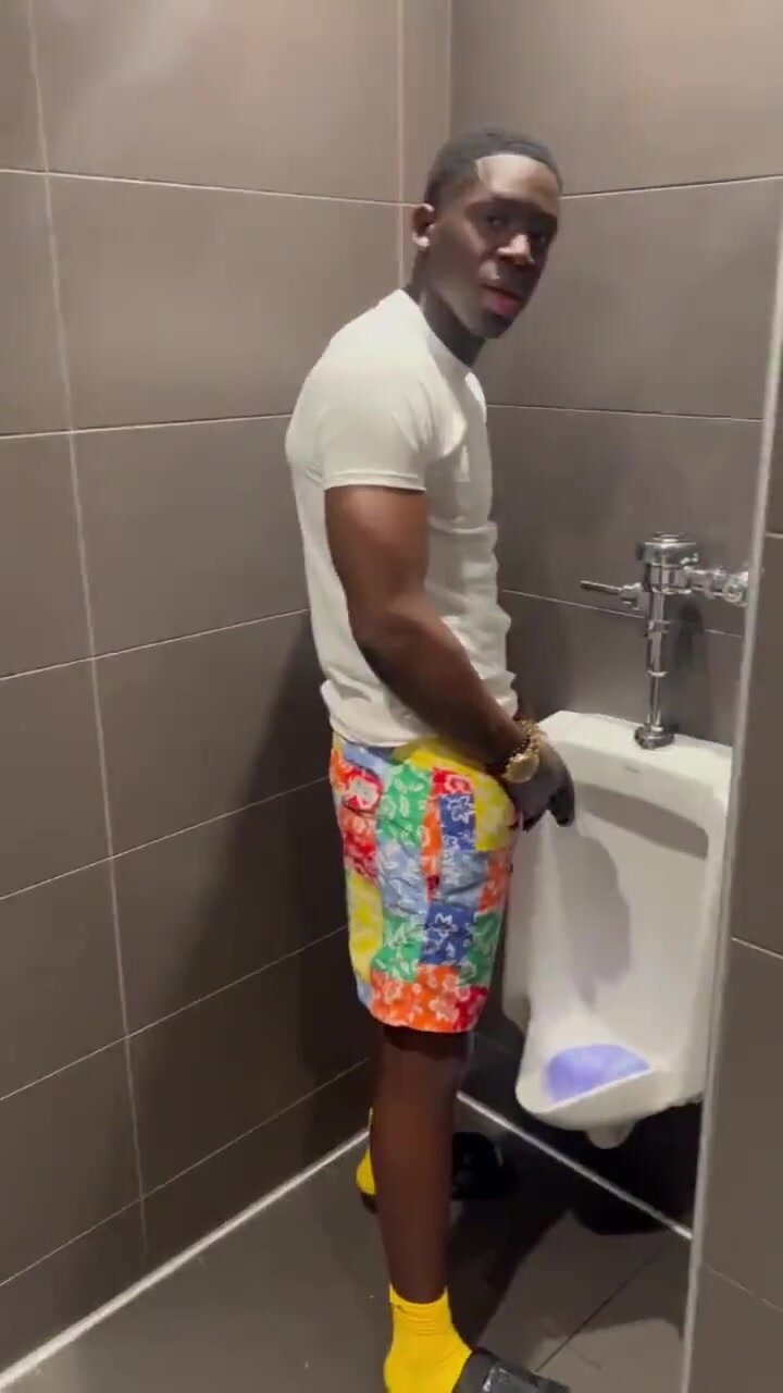 showing off his huge softie at urinal
