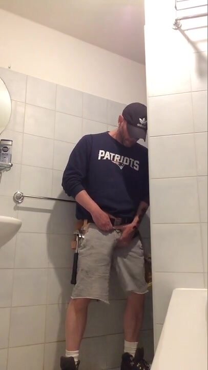 construction worker pisses himself in front of toilet