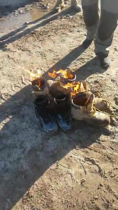 Workers burn their hot worn boots at end of project