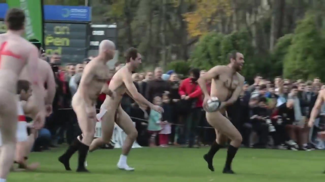 Naked rugby men playing outdoor