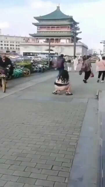 girl shitting on the street