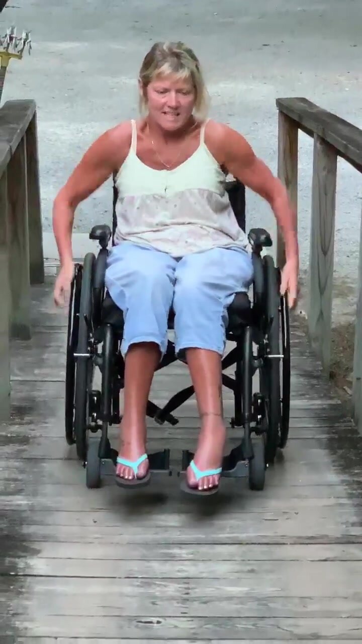blonde paraplegic in wheelchair struggling