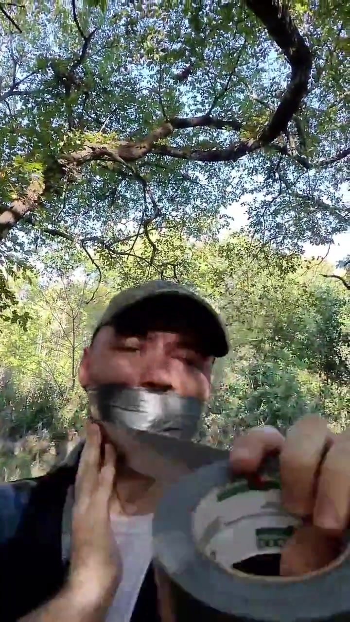 The guy seals his mouth with tape to himself.