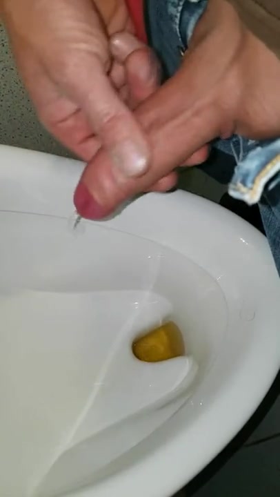 Piss wank in public urinal