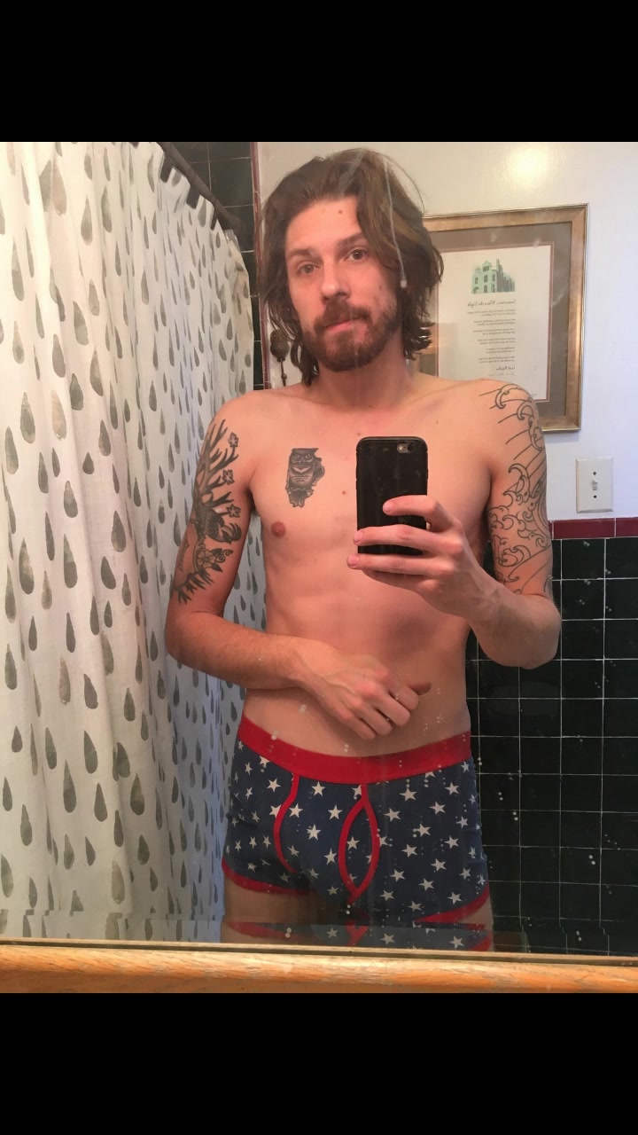 Lanky tattooed guy with long hair masturbates until he ejaculates