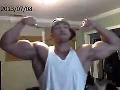 Huge Latino bodybuilder flexing his biceps and chest
