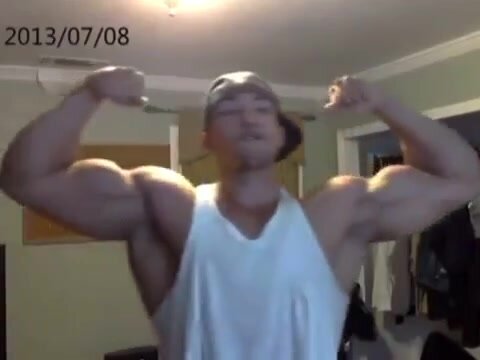 Huge Latino bodybuilder flexing his biceps and chest