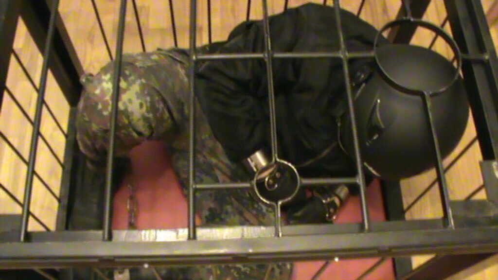 Shackled soldier slave in a cage - video 2