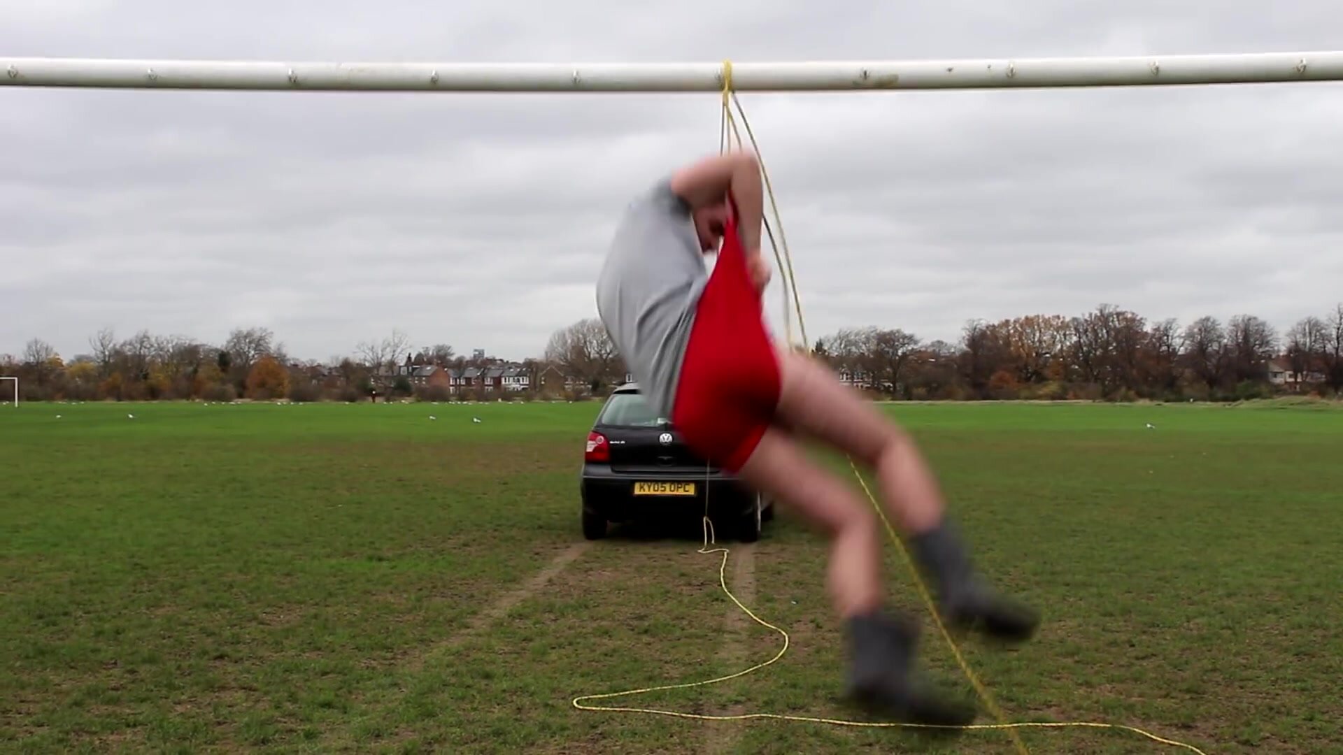 2 guys being car wedgied from a goal post