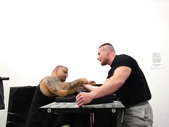 Huge strong and powerful stallions arm wrestling