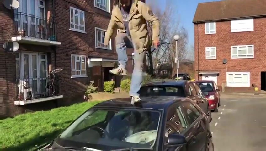Guy stomping roof of his car