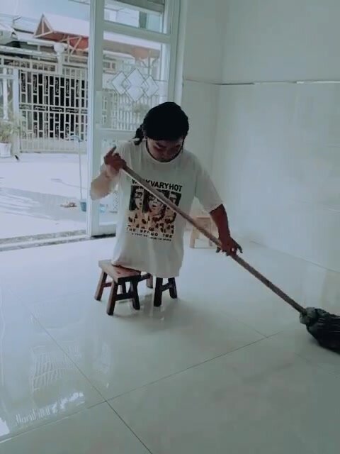 DHD girl sweeping the floor